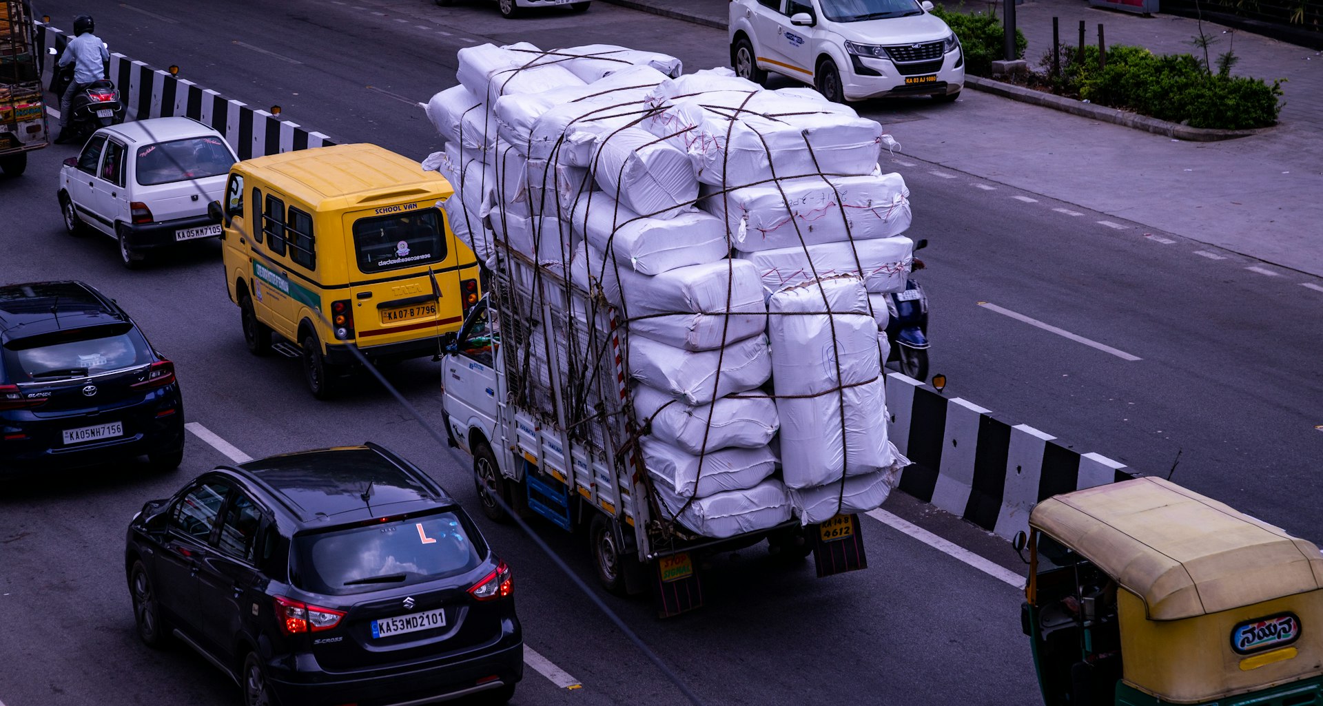 a truck with a load of bags on the back of it
